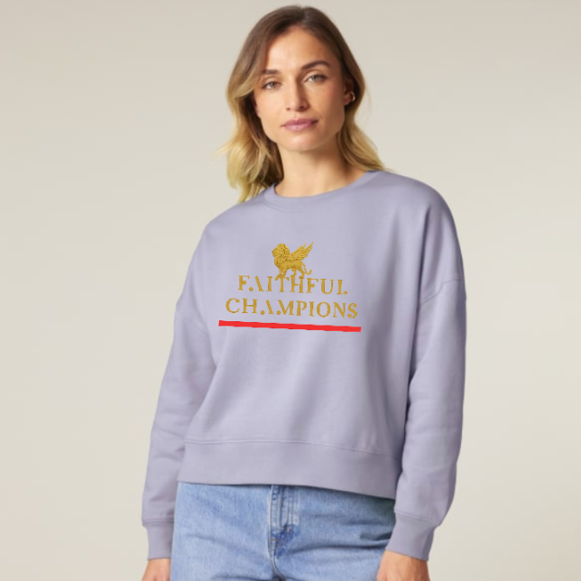 Woman wearing a light purple sweatshirt with 'Faithful Champions' text and logo on a plain background